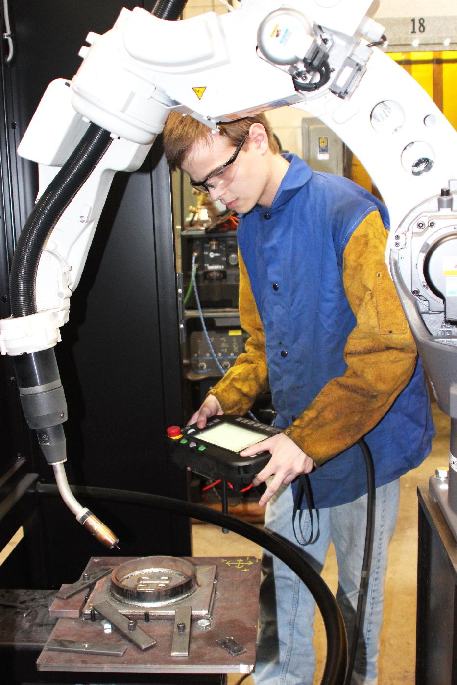 Student working with robotic welder